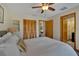 Bright bedroom featuring a ceiling fan, wood-look flooring, and ensuite bathroom for added convenience at 4035 N River View Ave, Tampa, FL 33607