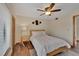 Bedroom with a queen bed, ceiling fan, wardrobe, and wood floors at 4035 N River View Ave, Tampa, FL 33607