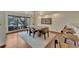 Bright dining area with waterfront views, featuring a modern chandelier and a rustic dining table at 4035 N River View Ave, Tampa, FL 33607
