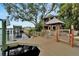 Exterior of waterfront house with dock, gazebo, outdoor seating, and bar for entertaining at 4035 N River View Ave, Tampa, FL 33607