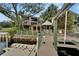 Waterfront property featuring a private dock, gazebo, outdoor living spaces and mature trees at 4035 N River View Ave, Tampa, FL 33607