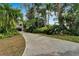Lush tropical landscaping surrounds this two-story home with stone accents, offering a private oasis at 4035 N River View Ave, Tampa, FL 33607