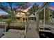 Waterfront home with a dock, a gazebo, outdoor furniture, and lush landscaping provides ideal outdoor living at 4035 N River View Ave, Tampa, FL 33607