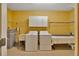 Laundry room with white cabinets, sink, washer, dryer, and ironing board for ease of chores at 4035 N River View Ave, Tampa, FL 33607