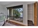 Bright living room view of the outside, featuring a chair, table, and large windows with a river view at 4035 N River View Ave, Tampa, FL 33607