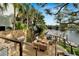 Inviting outdoor living space with wood furniture, built in grill, and views of the waterway at 4035 N River View Ave, Tampa, FL 33607