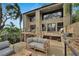 Spacious outdoor deck featuring comfortable seating, a grill, and lush tropical landscaping at 4035 N River View Ave, Tampa, FL 33607