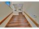 Hardwood staircase with wooden handrails and white walls leading to the upper level at 4035 N River View Ave, Tampa, FL 33607