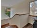 Stylish staircase featuring wood treads, a modern light fixture, and a view of the exterior at 4035 N River View Ave, Tampa, FL 33607