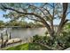 Scenic water view from the property, showcasing a private dock and mature trees at 4035 N River View Ave, Tampa, FL 33607
