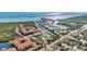 Aerial view of condo community with mature landscaping and water views, highlighted unit marked with red arrow at 4358 Outrigger Ln, Tampa, FL 33615