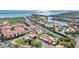 An aerial view of waterfront condos featuring terracotta roofing in a coastal community with boat docks and canal access at 4358 Outrigger Ln, Tampa, FL 33615