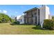 Townhouse backyard with a spacious screened-in lanai and a well-maintained lawn at 4358 Outrigger Ln, Tampa, FL 33615