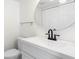 Bathroom with white vanity and toilet, round mirror, and minimalist design for a clean, modern look at 4358 Outrigger Ln, Tampa, FL 33615