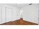 Bright bedroom with hardwood floors, double closet and white door, illuminated by a ceiling fan at 4358 Outrigger Ln, Tampa, FL 33615