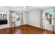 Bright bedroom with hardwood floors, two windows, ceiling fan, and decorated with beautiful curtains with colorful floral design at 4358 Outrigger Ln, Tampa, FL 33615