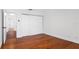 Bright, minimalist bedroom with hardwood floors, white walls, and ample closet space; fresh and modern at 4358 Outrigger Ln, Tampa, FL 33615