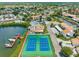 Aerial view of the community pool, tennis courts, boat docks, and waterfront homes at 4358 Outrigger Ln, Tampa, FL 33615