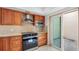 Well-equipped kitchen featuring wood cabinetry, stainless steel appliances, tile backsplash, and courtyard access at 4358 Outrigger Ln, Tampa, FL 33615