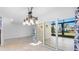 Open-concept room with large sliding glass doors for natural light and tiled floors, adorned with unique light fixture at 4358 Outrigger Ln, Tampa, FL 33615