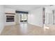 Open-concept living room featuring tile floors, fireplace, and sliding glass doors to the lanai at 4358 Outrigger Ln, Tampa, FL 33615