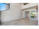 Covered patio featuring travertine flooring and sliding glass doors leading to the interior of the home at 4358 Outrigger Ln, Tampa, FL 33615