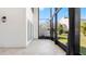 Spacious screened-in patio with travertine flooring, offering views of the outdoors and access to the house at 4358 Outrigger Ln, Tampa, FL 33615