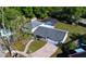 An aerial view shows a charming home with a screened-in pool and well-manicured lawn and driveway at 500 Hillpine Way, Brandon, FL 33510