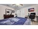 Comfortable bedroom featuring a queen-size bed, dresser, TV, neutral walls, and wood-look flooring at 500 Hillpine Way, Brandon, FL 33510