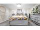 Comfortable bedroom with a decorative bed frame, bedside lamps, and dresser with a mirror at 500 Hillpine Way, Brandon, FL 33510