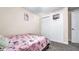 Bedroom with a cozy bed, pink comforter, closet, and small basketball hoop at 500 Hillpine Way, Brandon, FL 33510