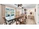 Dining area with a long wooden table, comfortable seating for six, and sliding doors opening to an outdoor area at 500 Hillpine Way, Brandon, FL 33510