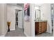 Hallway shot leading to a bathroom and closet with carpet flooring and neutral paint at 500 Hillpine Way, Brandon, FL 33510