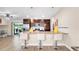 Kitchen with wooden cabinets, granite countertops, stainless steel appliances, pendant lighting, and barstool seating at the counter at 500 Hillpine Way, Brandon, FL 33510