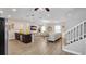 Bright living room showcasing an open layout, modern decor, wood flooring, and a kitchen island with barstool seating at 500 Hillpine Way, Brandon, FL 33510