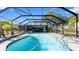 An inviting screened-in pool is surrounded by greenery, offering a private backyard oasis for relaxation and recreation at 500 Hillpine Way, Brandon, FL 33510
