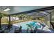 A stunning screened-in pool with lush greenery and a charming patio area, perfect for relaxation and entertaining at 500 Hillpine Way, Brandon, FL 33510