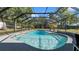 The screened-in pool is a refreshing oasis surrounded by tropical landscaping and providing a tranquil retreat at 500 Hillpine Way, Brandon, FL 33510