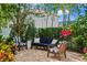 Cozy backyard patio with stylish furniture and vibrant hibiscus, creating a serene outdoor space at 5024 W Homer Ave, Tampa, FL 33629