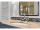 Bathroom vanity featuring double sinks and a shower reflected in the decorative mirror at 5024 W Homer Ave, Tampa, FL 33629