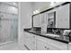 Bathroom with a glass enclosed shower, double vanity, and granite countertops at 5024 W Homer Ave, Tampa, FL 33629
