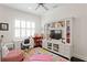 Bright bedroom with a white built-in entertainment center, desk and colorful rug at 5024 W Homer Ave, Tampa, FL 33629