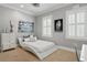 Light and airy bedroom with gray walls, two windows and modern decor at 5024 W Homer Ave, Tampa, FL 33629