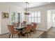 Bright dining area featuring a wooden table, decorative chandelier, and access to the outdoor space at 5024 W Homer Ave, Tampa, FL 33629