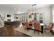 Open concept view of the dining room leading to the living room with fireplace and tv at 5024 W Homer Ave, Tampa, FL 33629