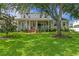 Charming two-story home featuring a spacious front porch, well-manicured lawn, and beautiful landscaping at 5024 W Homer Ave, Tampa, FL 33629