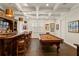 Entertainment room featuring a pool table, wet bar with seating, and custom lighting at 5024 W Homer Ave, Tampa, FL 33629