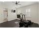 Bright home gym featuring an exercise bike, treadmill, rubber floor, ceiling fan, and access to a bathroom at 5024 W Homer Ave, Tampa, FL 33629