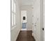 Hallway with hardwood floors leading to a powder room featuring a vessel sink and stylish vanity at 5024 W Homer Ave, Tampa, FL 33629