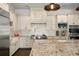 Gourmet kitchen featuring premium appliances, custom cabinetry and granite countertops at 5024 W Homer Ave, Tampa, FL 33629